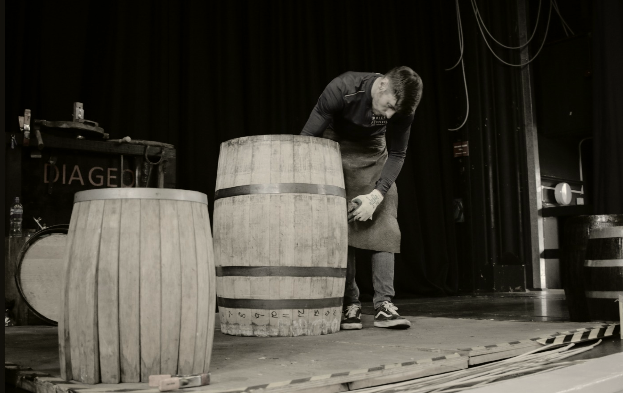 Background image of a man rolling out a barrel
